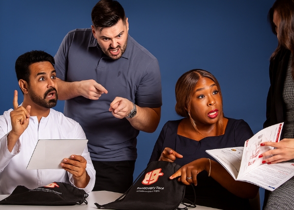 Conflict management training roleplay with professionals in animated discussion.