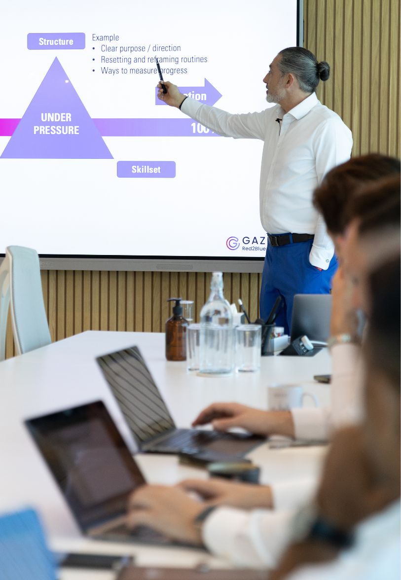 Corporate trainer delivering leadership training presentation at Ignite session.