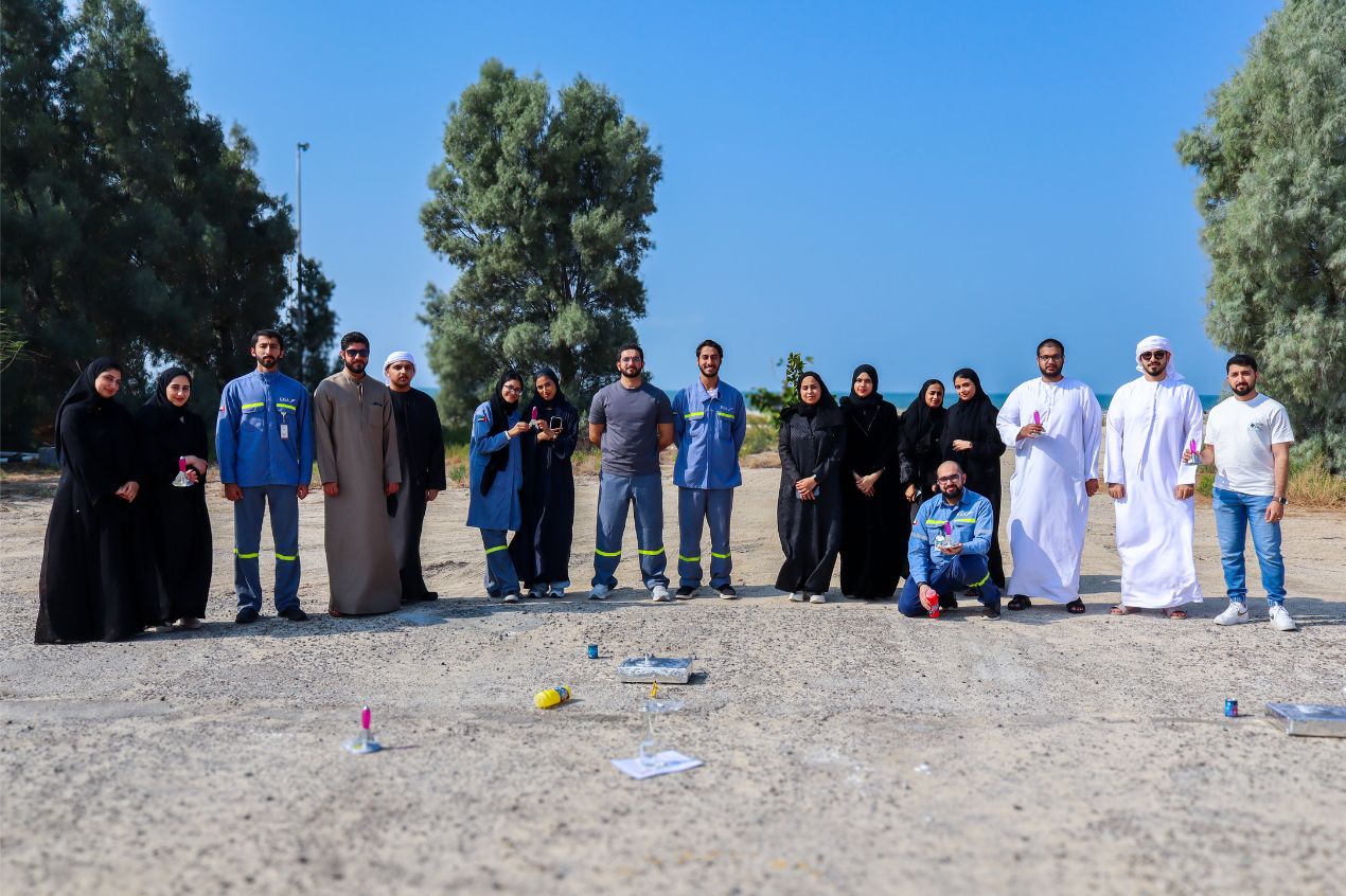 EGA LEAP graduate trainees standing together outdoors during a leadership team-building activity.