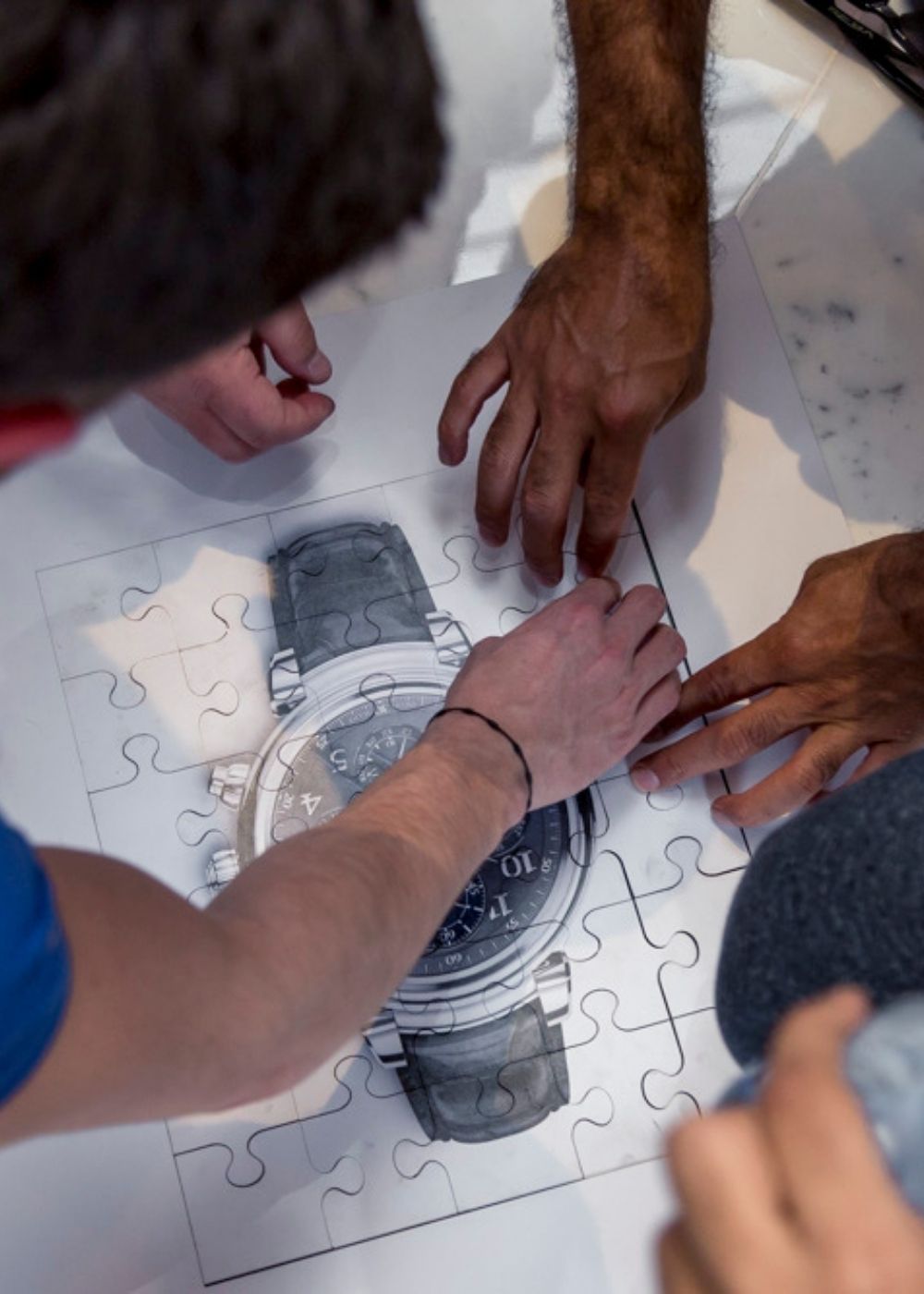 Team collaborating on a jigsaw puzzle
as part of a corporate team building activity.